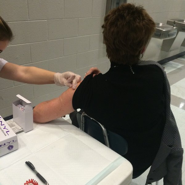 Dr. Leisa Justus, principal, gets her annual flu shot at a shot clinic set up by Jamie Ramangkoun, senior, at a BHS basketball game. Jamies clinic was one of the Capstone projects for Blackman Collegiate Academy.