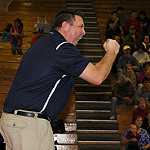 Photo courtesy of www.blackmanwrestling.com. Coach Ronnie Bray cheers on his wrestlers.