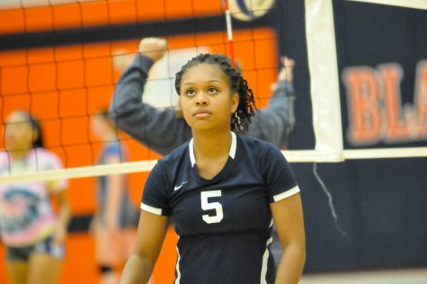 Kelci Williams, senior, warms up before the team's match against LaVergne