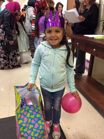 This little girl flashes a sweet smile on her birthday celebration.