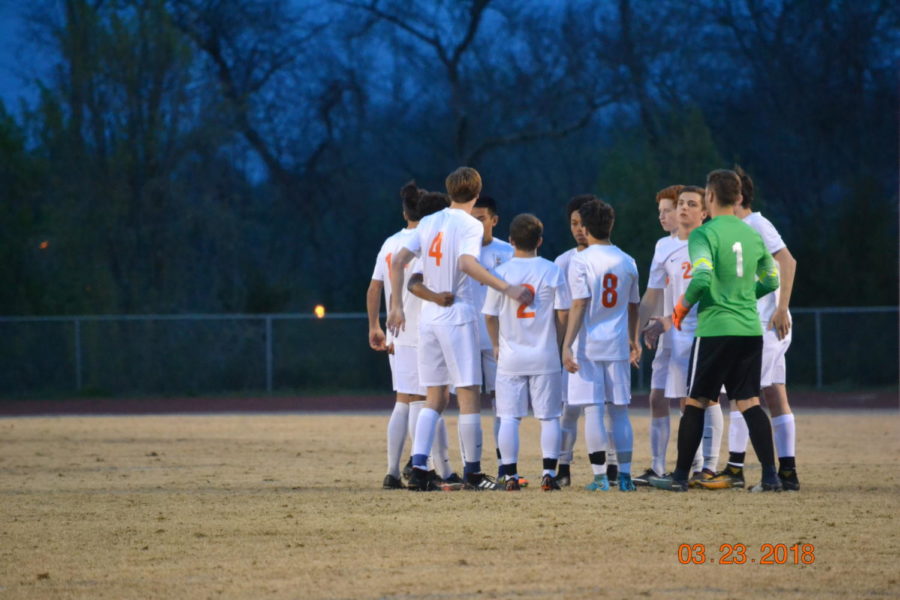 The starting 11 huddle up to pray before the game.
