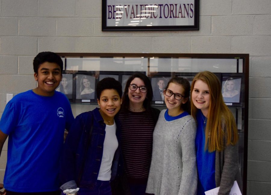 Some of the students at orientation in front of the BHS Valedictorians display.