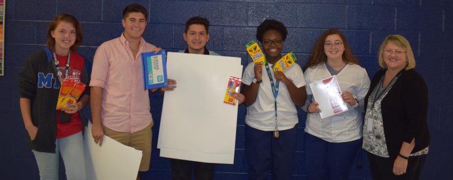 (Pictured from left to right) Morgan Stephens, sophomore; Julian Young. Carlos Coronel ,Keyah Suel, Kelsi McGregor, seniors, pictured with Kim Garrott, Atlas coordinator

Blackman Cares Club finish their school drive by giving the supplies to Garrott for Atlas students.