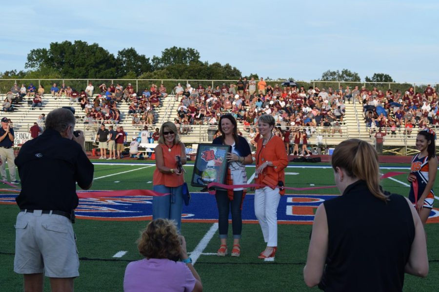 Dr. Justus, Kelli Beam, and Clarissa Smith cut the ribbon to the to the newly announced Bart Smith Field at the Inferno!