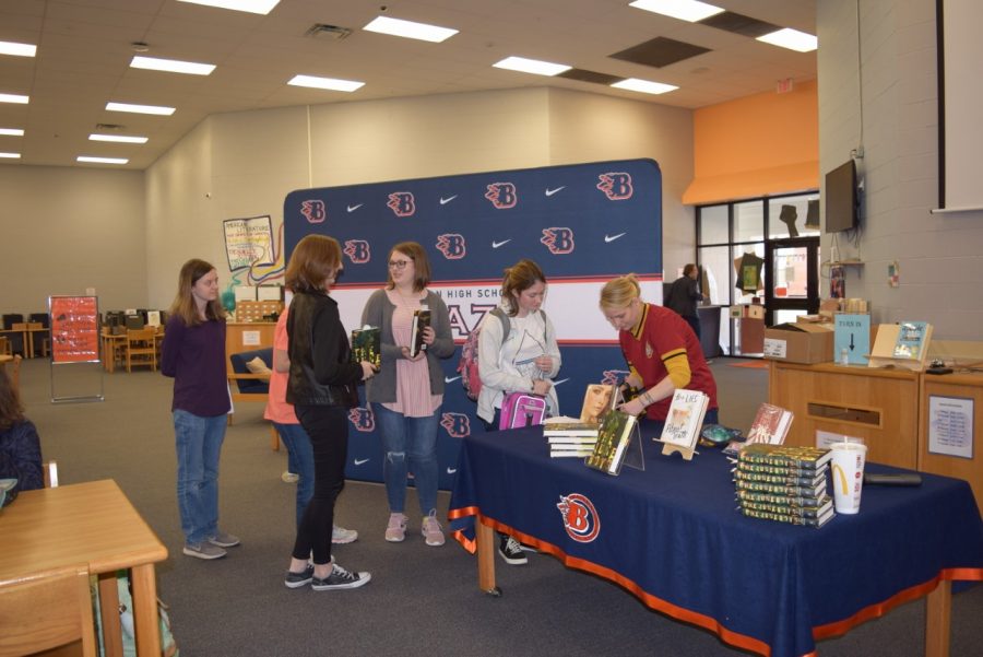 Students getting their book signed by Courtney Stevens.
