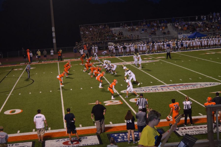 The football team lines up, ready for the beginning of the third quarter.