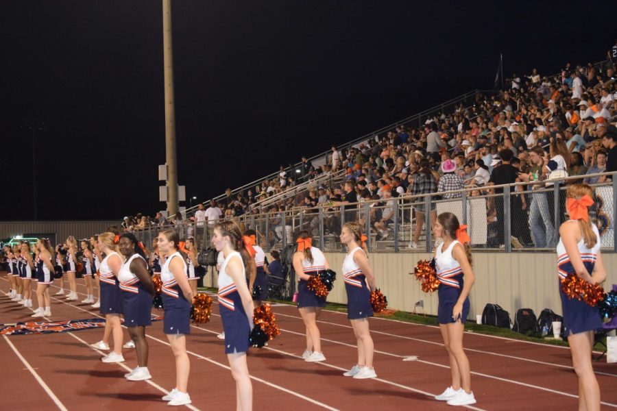 The Dance Team watches the Blackman Blaze band perform the half-time show.