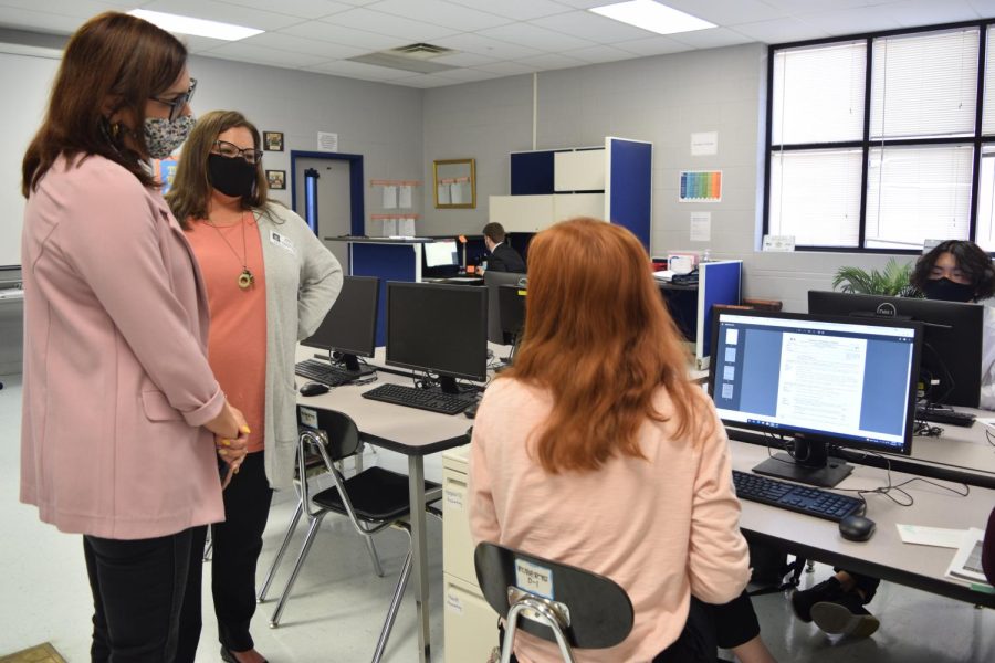 Jillian Berg (Southern Region Director for Virtual Enterprise) and Amanda Bowlin (Southern Region Program Coordinator for Virtual Enterprise) evaluate a students work as they visit the company. 