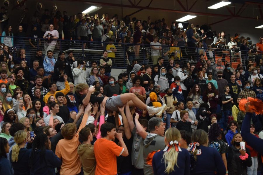Senior Chandler White is crowd surfed during the March 9th pep rally. 