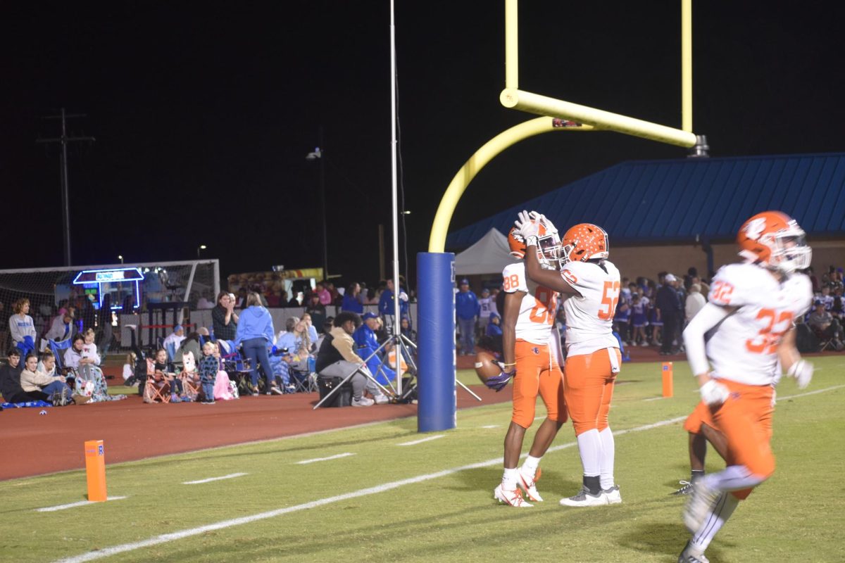 Blackman player crowning Jaden Guy after touchdown