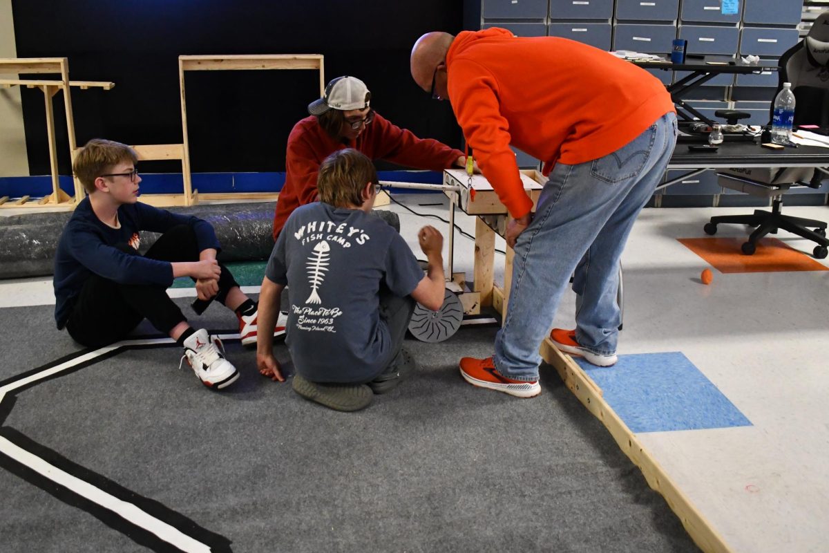 Forrest Norton, Chase Bowes, Preston Bowes, and Zach Martin  working on the robot dock