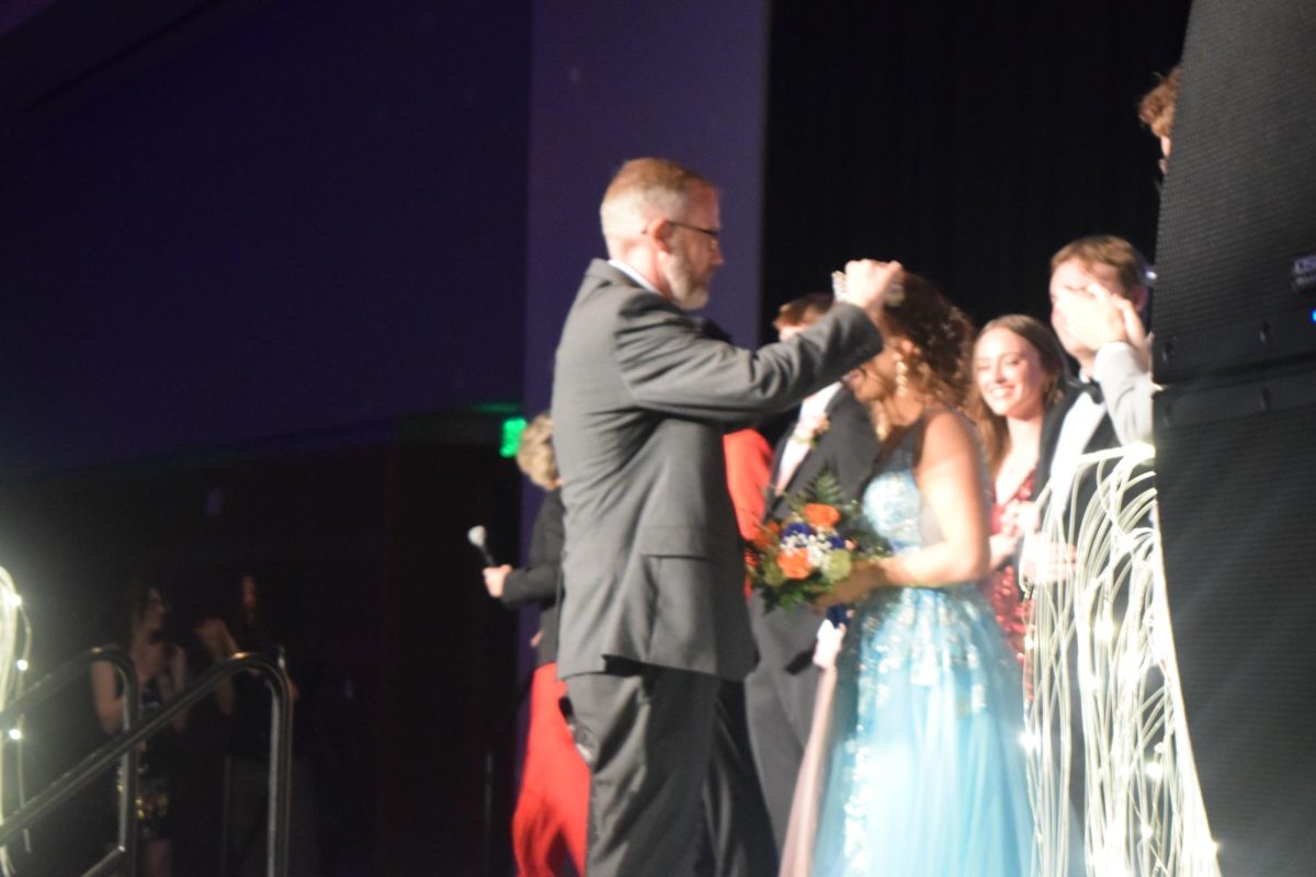 Principal Justin Smith crowning Prom Queen.