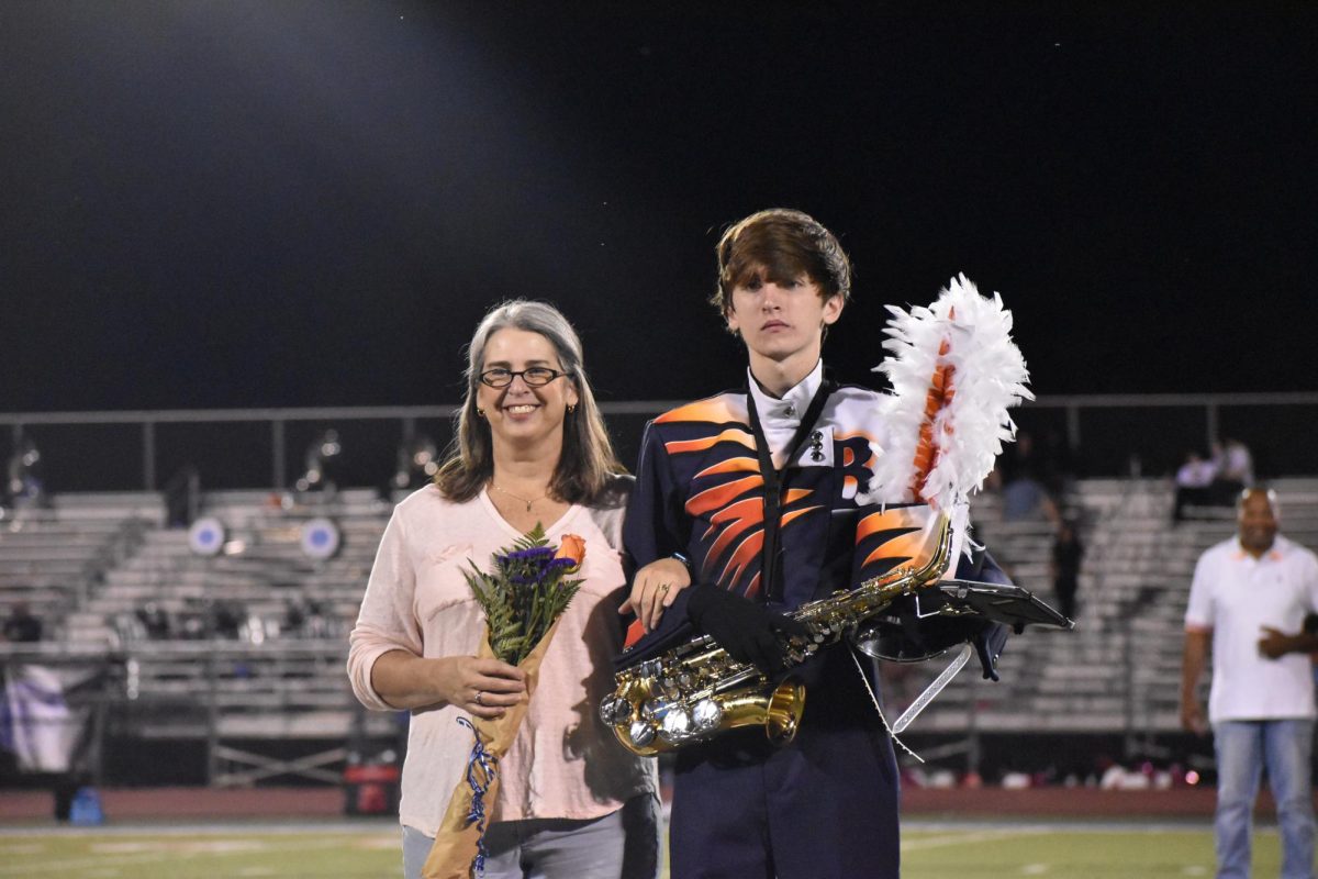 Senior James Olexy with escort