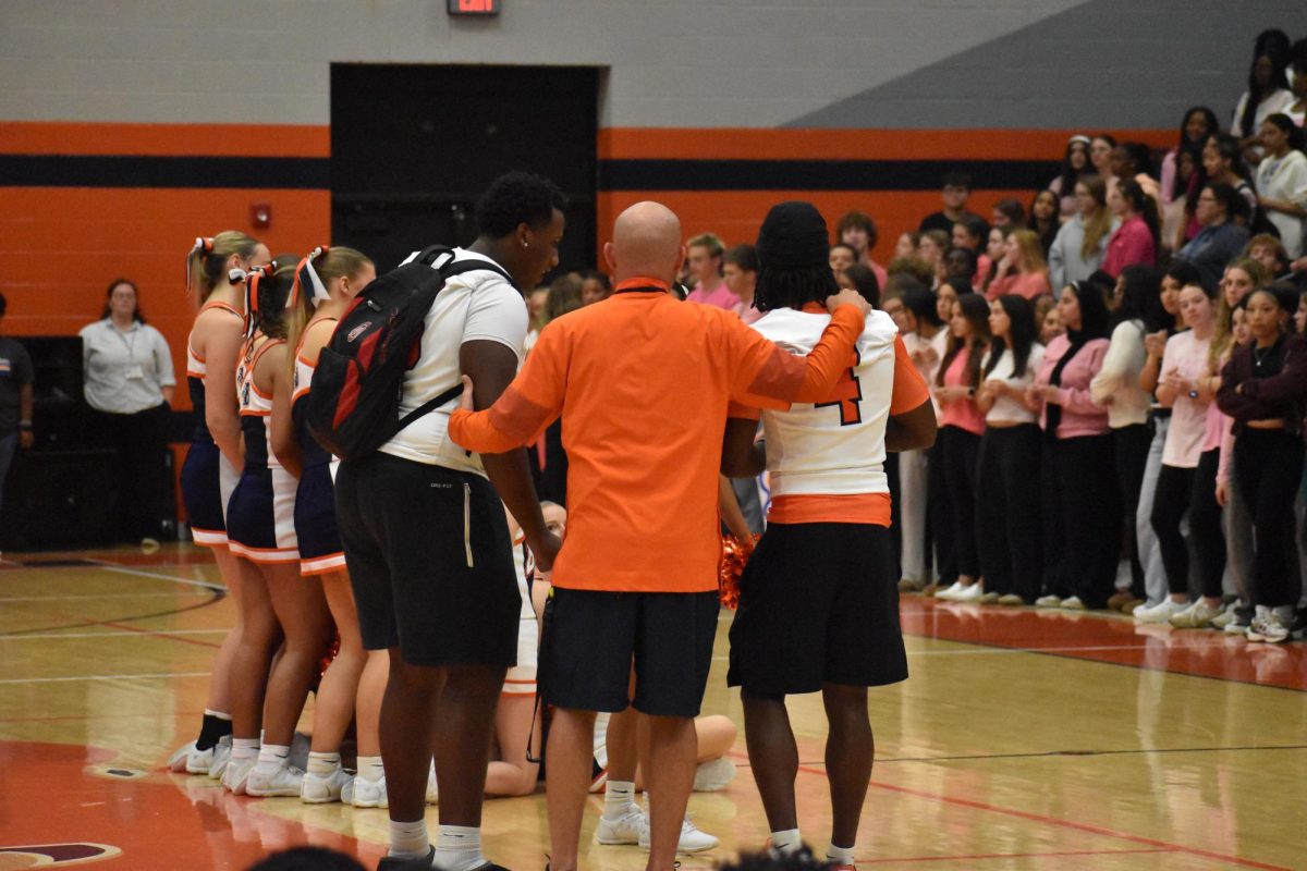 Kennedy Jackson, coach Kriesky, and Jaden Lark getting the pep rally hype