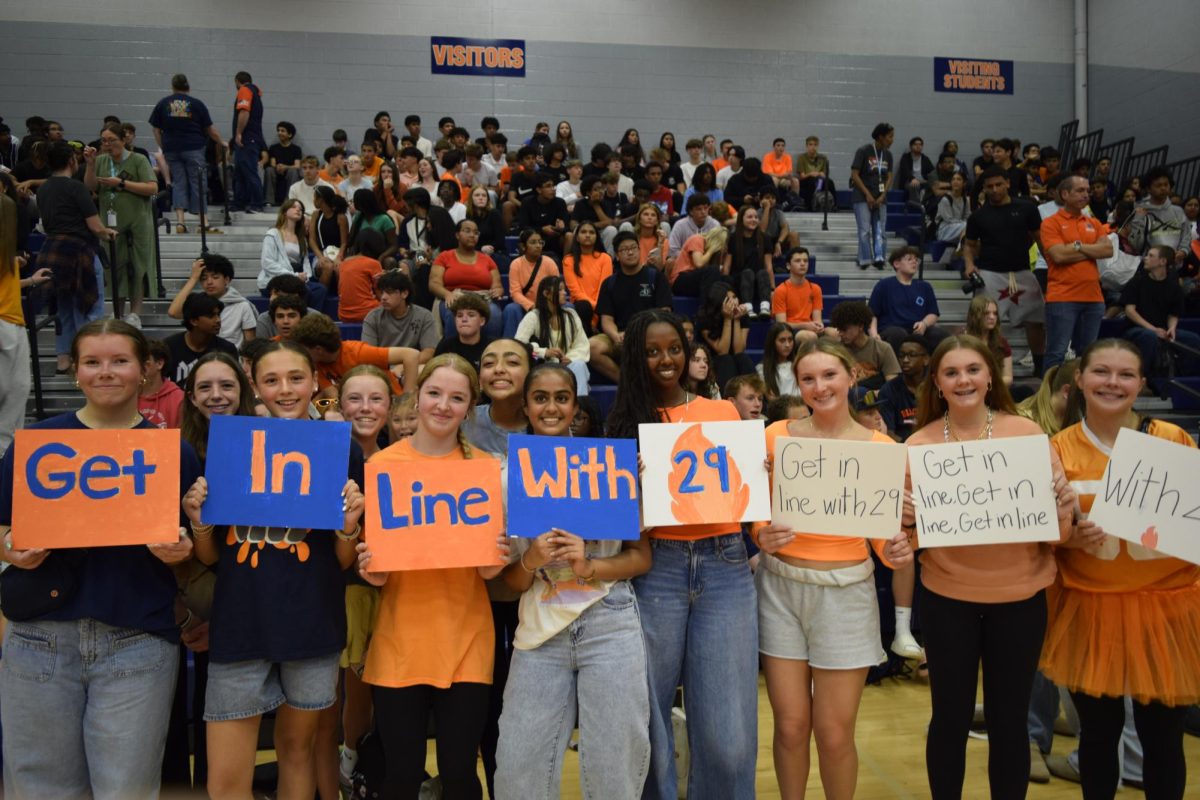 Freshmen holding up "Get In Line With '29" signs for spirit day. 