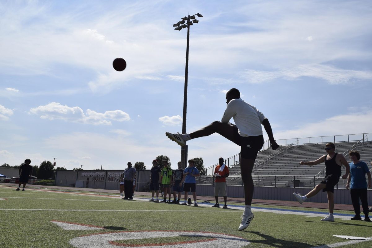 Student taking part in Blaze Bash kickball game.