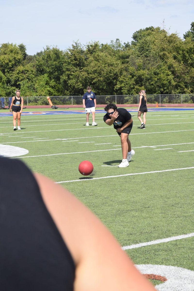 Student Dominick Ferreira pitching in Blaze Bash kickball. 