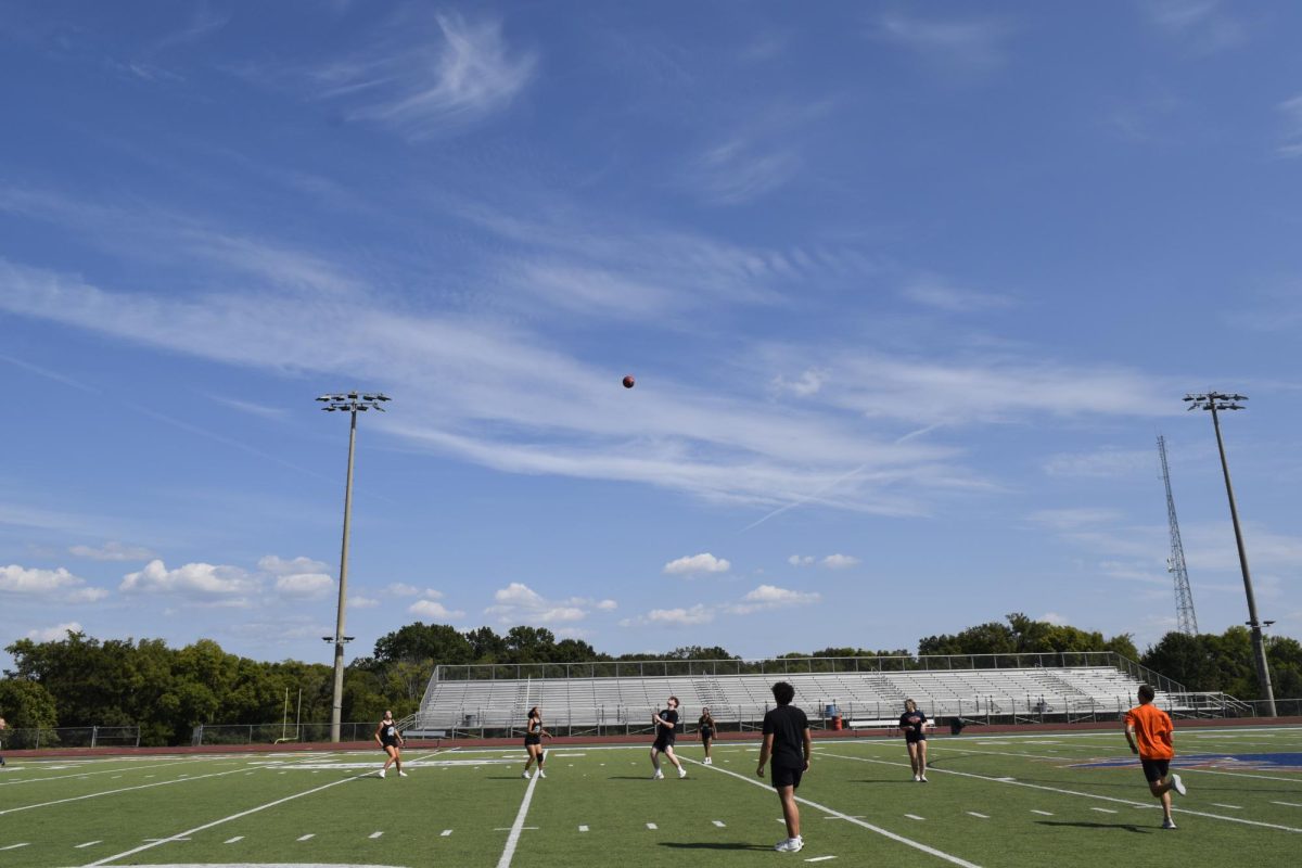 Students in the outfield participating in kickball. 