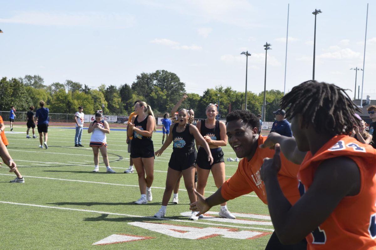 Students Kennedy Jackson and Sofia Williams cheering on participators of kickball. 