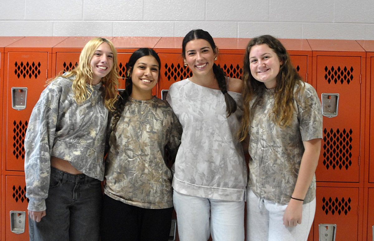 A group of students all participating in camo day at school