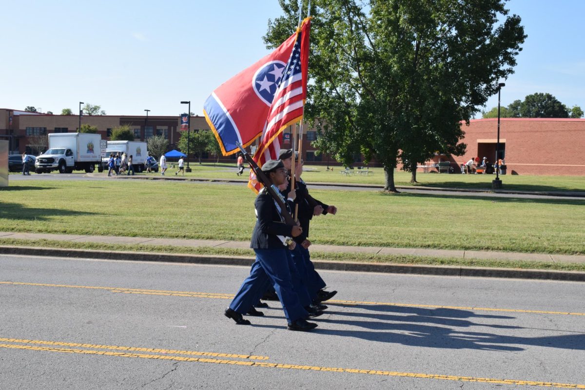 JROTC Rifle team marching with flag