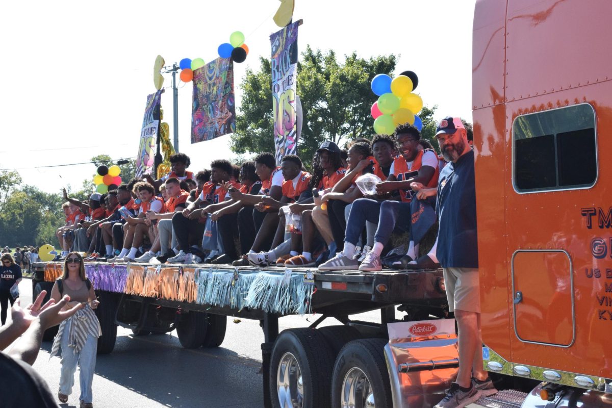 Football team sitting on a truck
