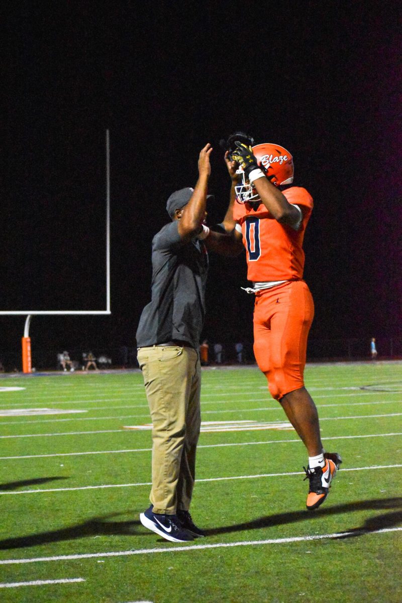 TJ Johnson celebrating with a coach