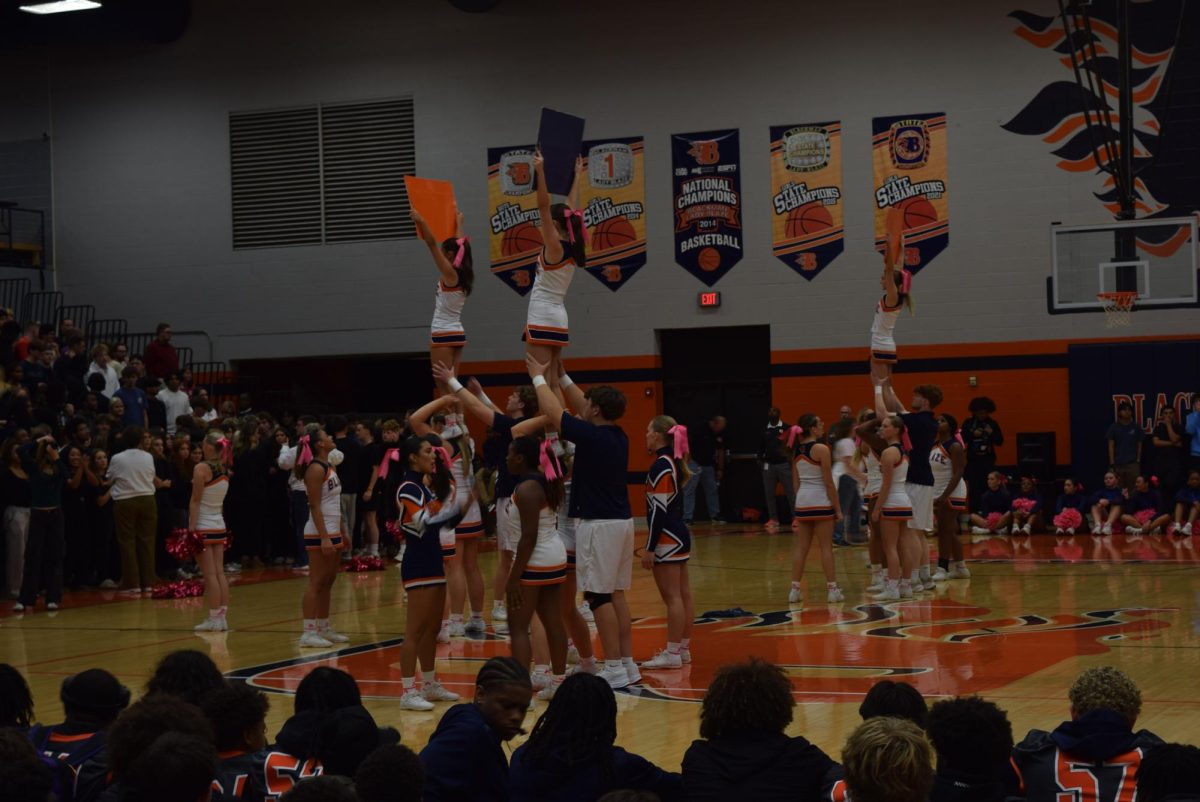 Cheerleaders holding signs that read "GO" 