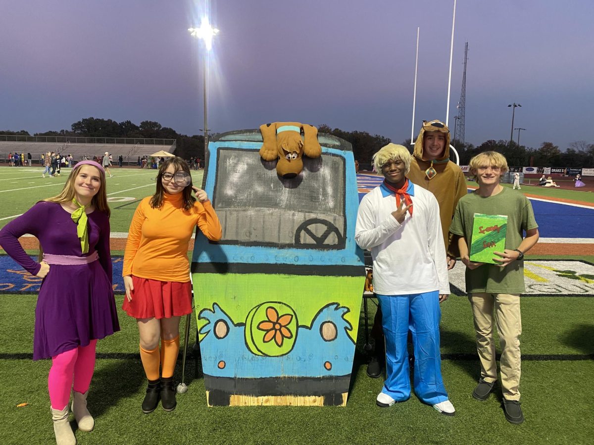 Students posing at track or treat
