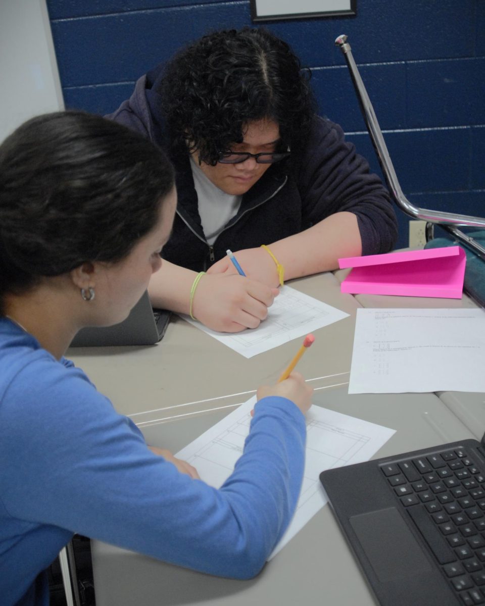 11th graders Valeria and Billy working hard on a math station
